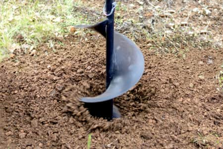 Construction auger digging hole